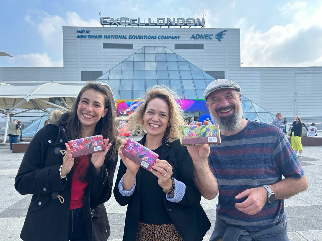 Group photo of three consultants smiling and standing together, showcasing teamwork and professionalism.